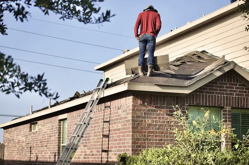 Professional roofer working on a residential roof in Hendersonville